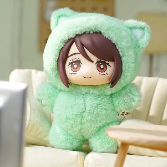 Plush blind box toy with a character design sitting on a couch in a room.