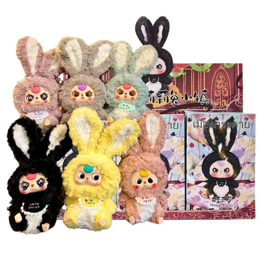 Set of colorful blind box plush toys with bunny ears and a packaging box on a white background