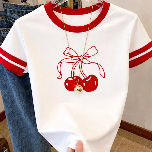 White t-shirt with red accents and cherry design on a hanger.