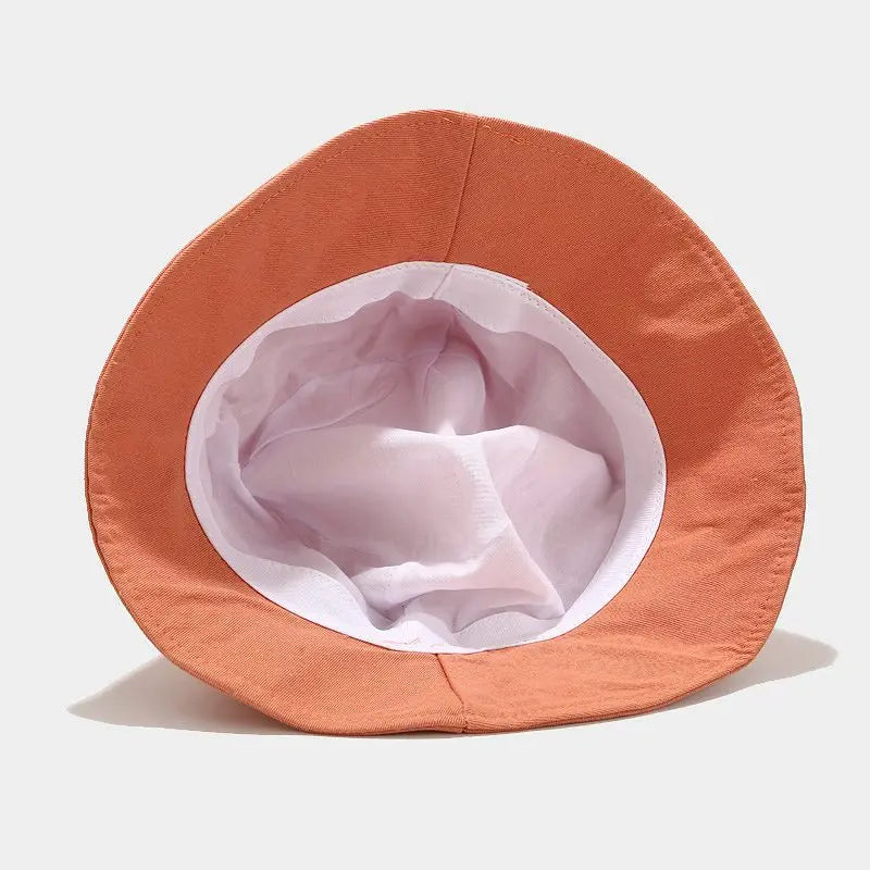 Orange hat with a white interior on a light gray background