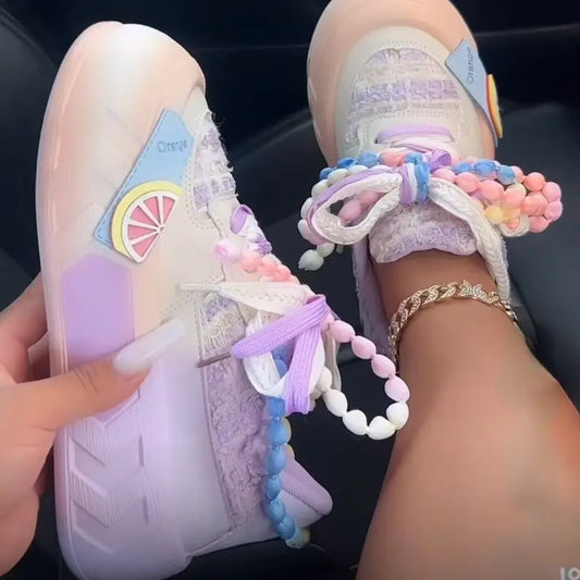 Kawaii Pastel-colored sneakers with decorative pearl elements on a dark background