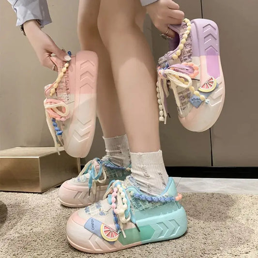Kawaii pastel pearl sneakers being displayed by a person wearing them and also holding a pair