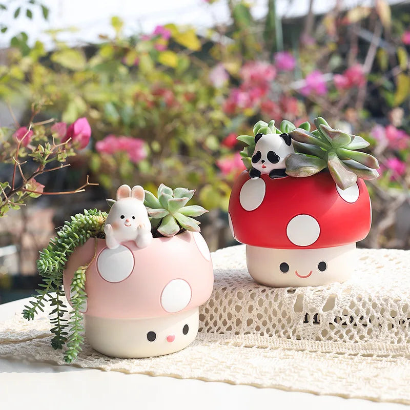 Two mushroom-shaped planters with cute animal figurines on top, set against a blurred garden background.