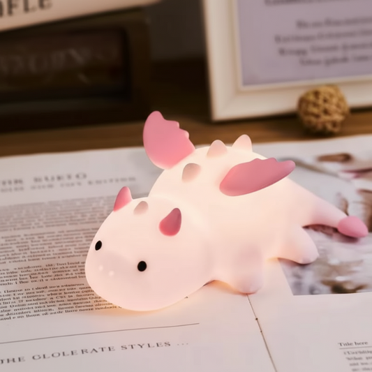Cute dragon-shaped night light on an open book