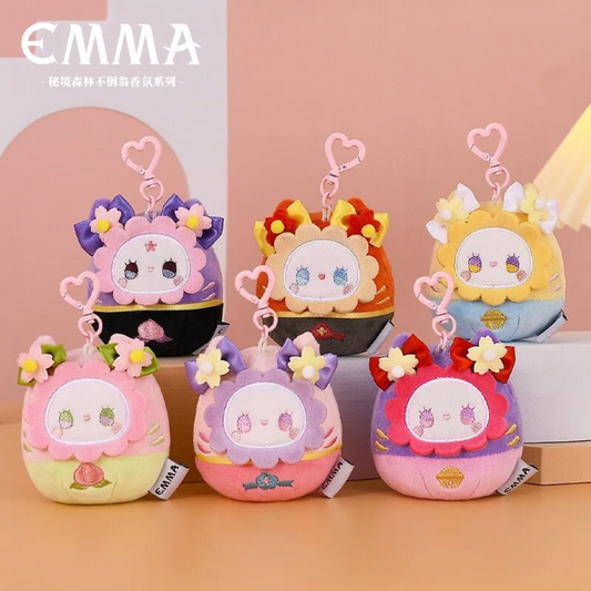 Set of kawaii plush Emma keychains with cartoon faces on a pink background