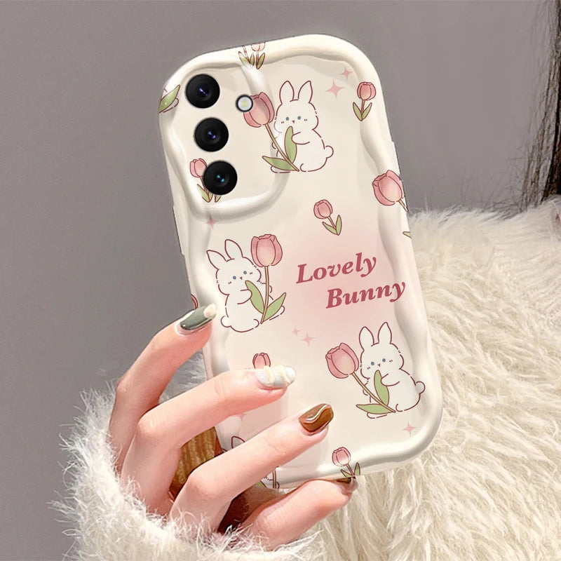 Phone case with bunny and tulip design held by a hand against a neutral background