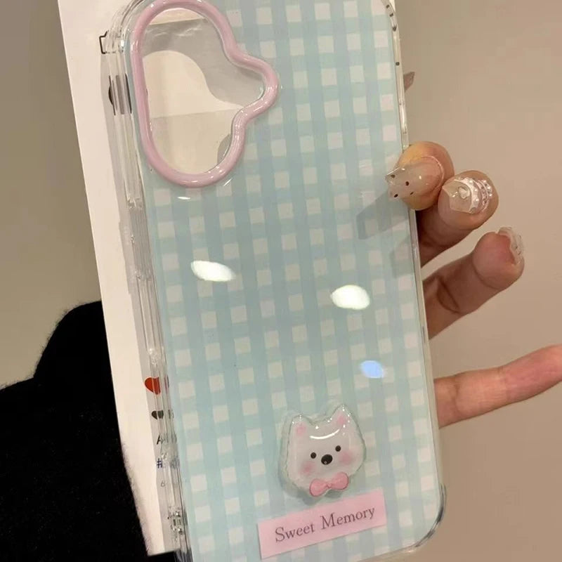 Phone case with a checkered pattern and cute design held by a hand.