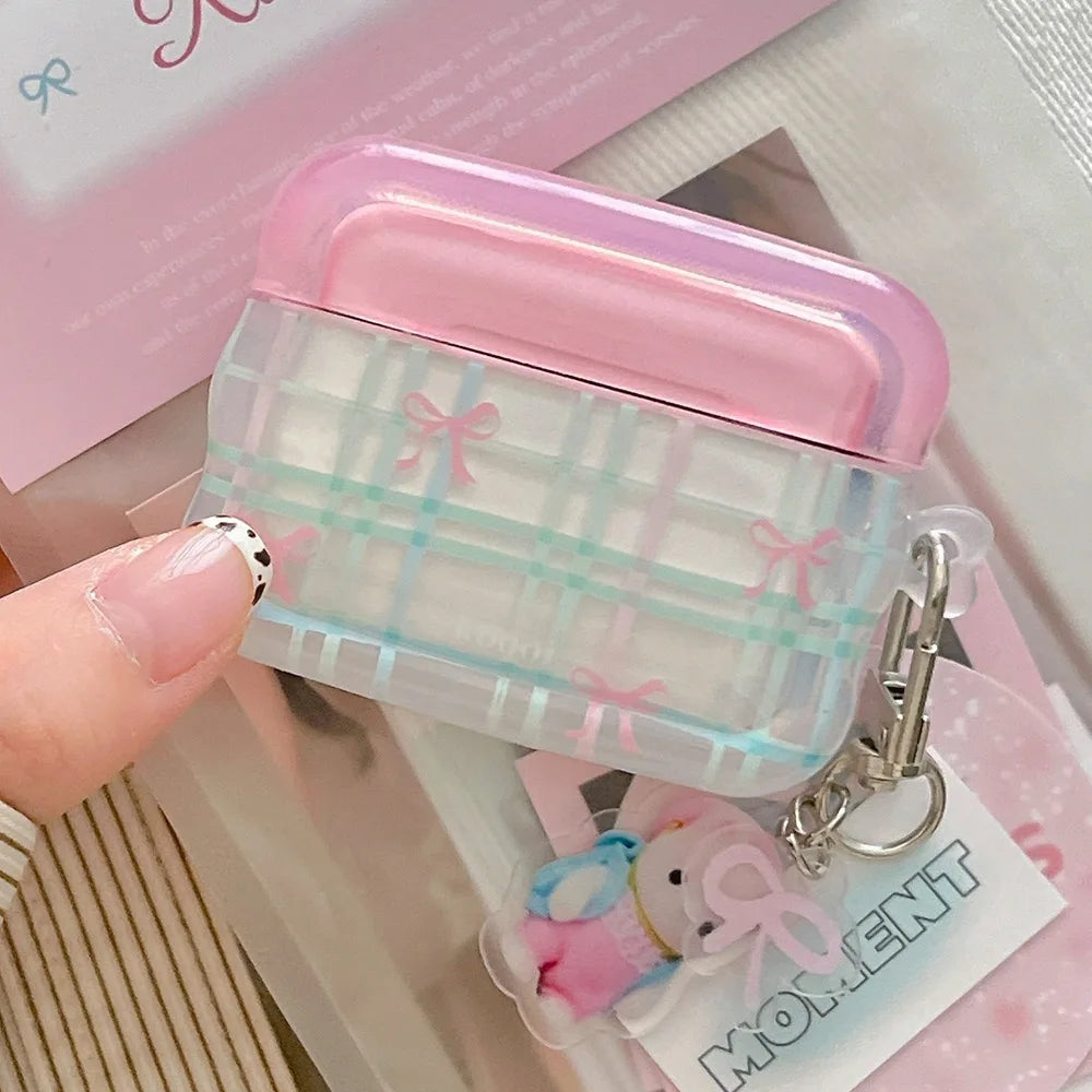 Clear case with pink top and plaid pattern, held by a han.