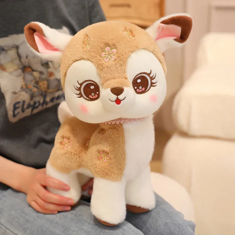 kawaii deer plushie in brown on a person's lap.
