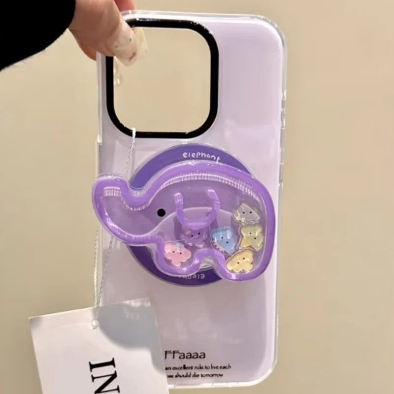 a woman holding a white phone case with a kawaii cute elephant quicksand phone grip , this is in the color purple with colorful elephant faces inside on a white background.