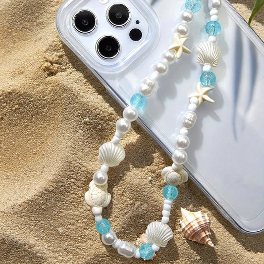 Mermaid treasure phone charm bracelet displayed on sandy beach