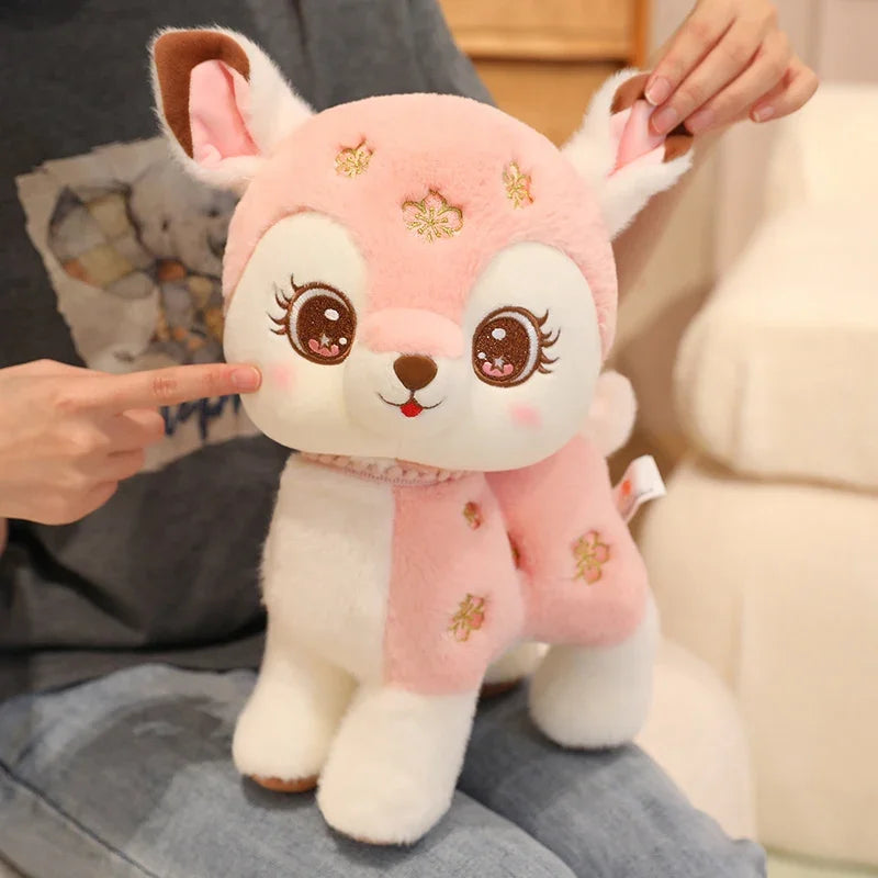 Kawaii pink deer plushie on a person's lap