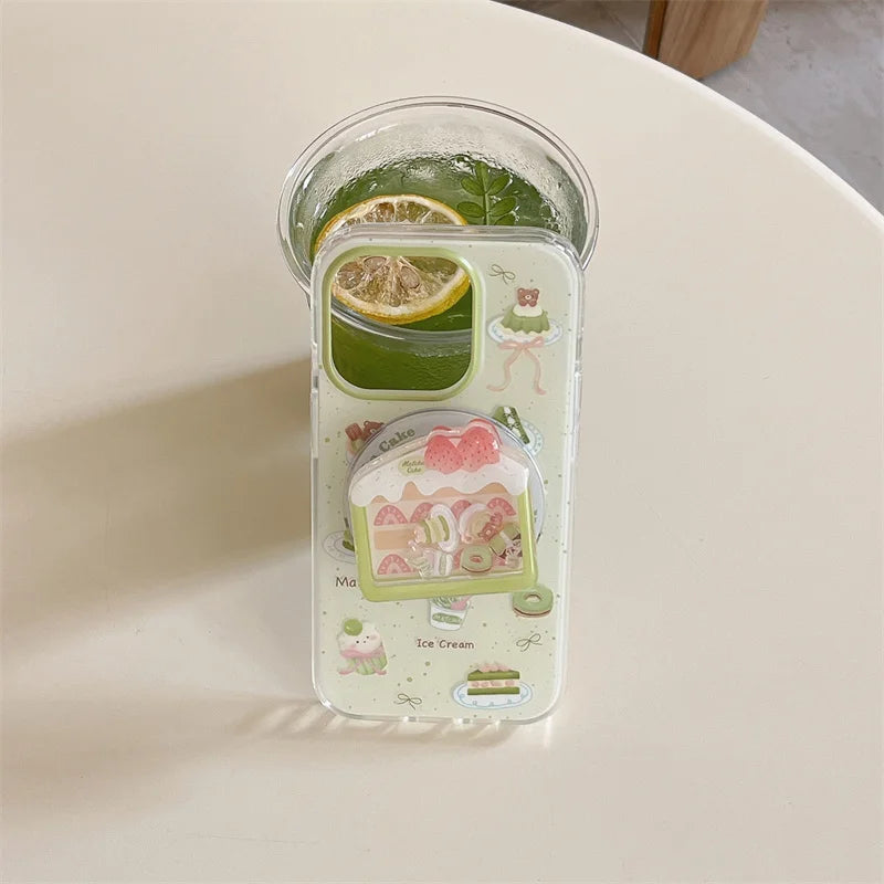Kawaii Matcha Cake Phone Grip, this displays the set that has a case and grip together , this is displayed in front of an iced matcha drink.
