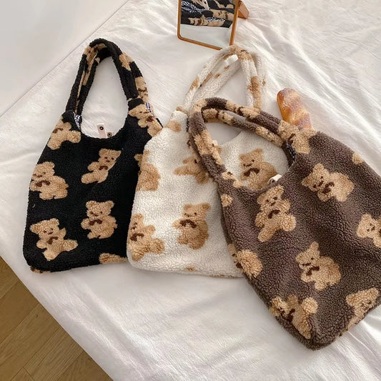 Three plush bags with teddy bear patterns on a white surface
