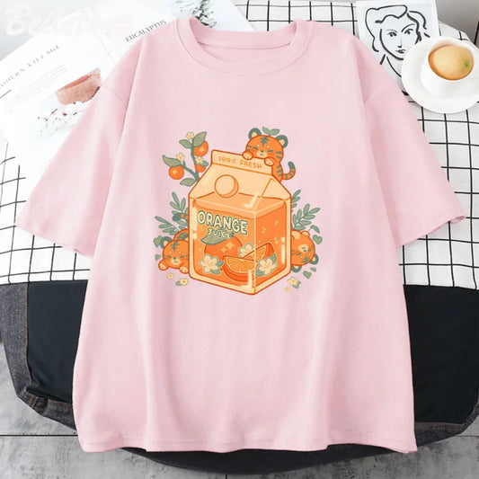 Pink t-shirt with orange juice carton and tiger graphic on a checkered tablecloth.