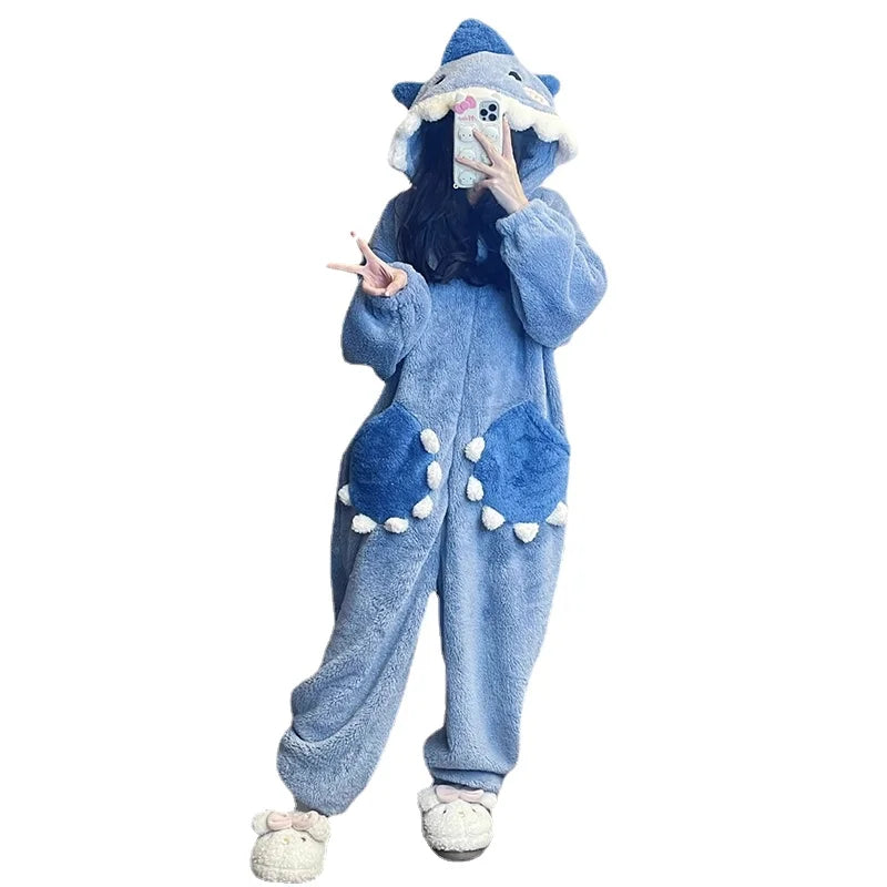 Person wearing a blue shark onesie on a white background