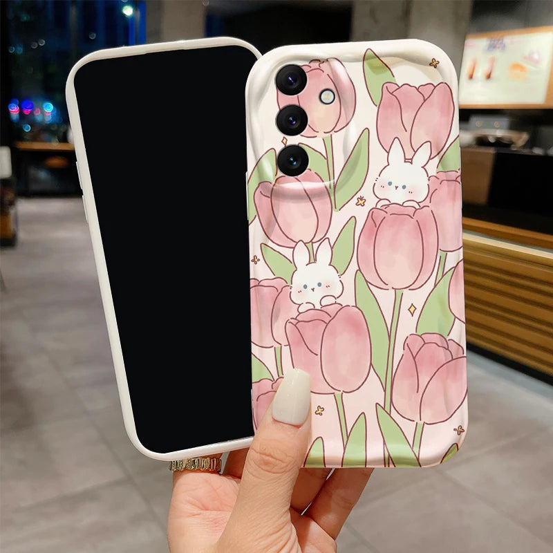 Phone case with pink tulips and bunnies held by a hand in an indoor setting