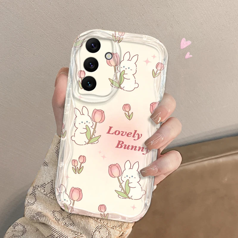 Phone case with bunny and tulip design held by a hand against a neutral background