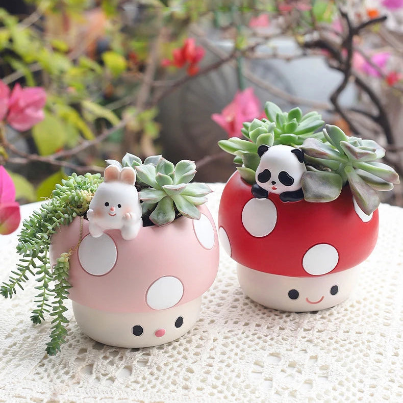 Two cute mushroom-shaped planters with succulents and small animal figurines on a textured surface.