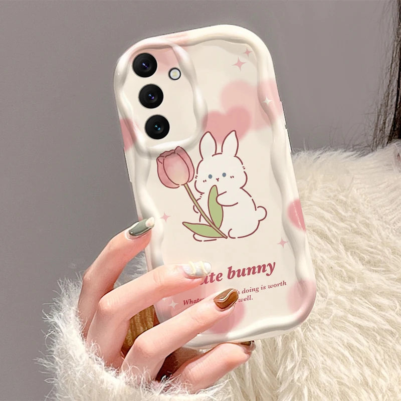 Phone case with a cute bunny design held by a hand against a neutral background