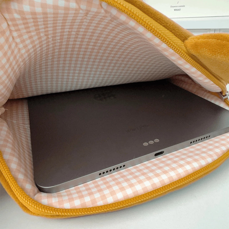 Tablet in the interior of the tablet sleeve that has a pink checkered design with yellow zipper