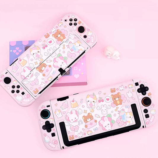 Two gaming consoles with cute animal and heart patterned stickers on a pink background