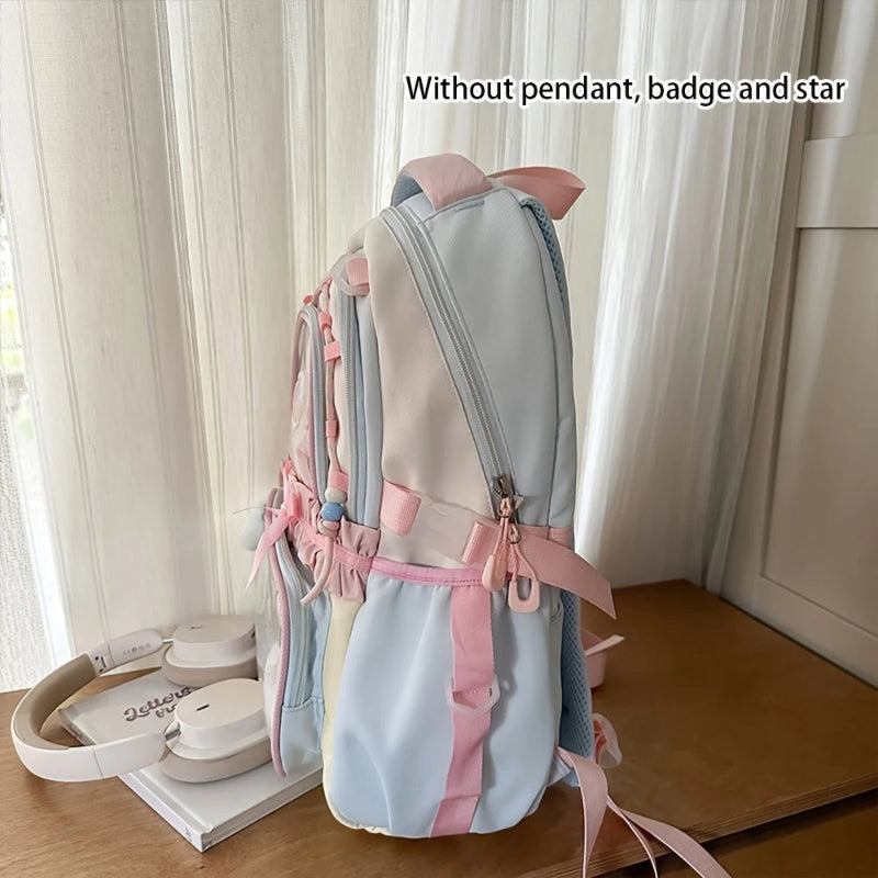 Light blue and pink backpack on a wooden surface.
