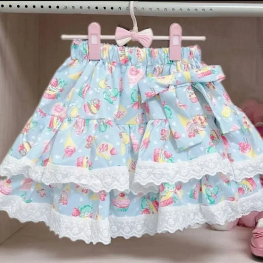 Blue skirt with colorful pattern and lace trim hanging on a rack.
