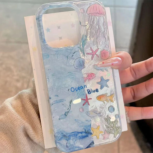 Phone case with ocean-themed design held by a hand