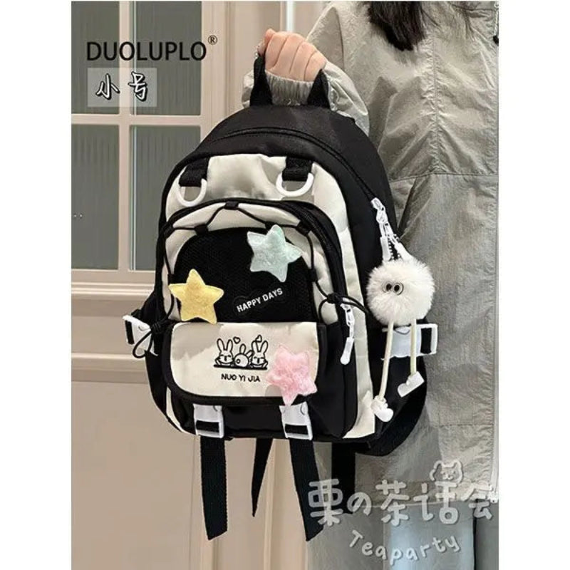 Kawaii backpack with star designs being held by a person
