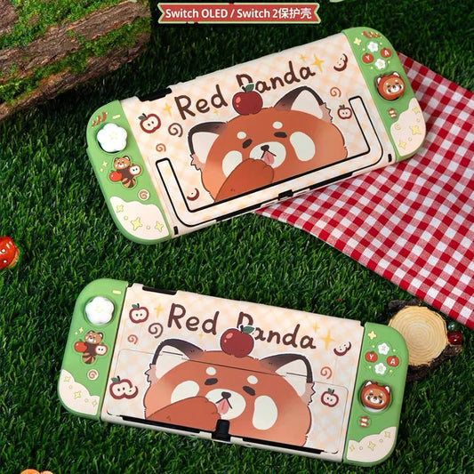 Two red panda-themed Nintendo switch cases on grass with a checkered cloth in the background