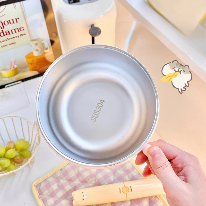 Metallic bowl held by a hand on a kitchen counter with a blurred background