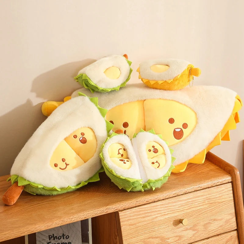 Plush toys shaped like durian on a wooden surface with a neutral background