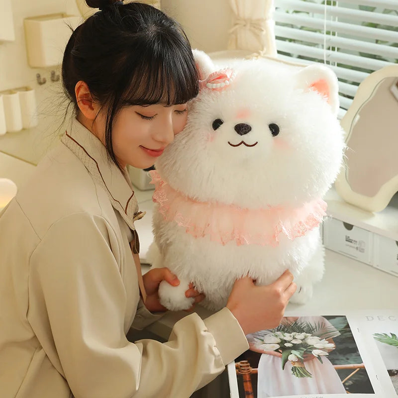 Person holding a large white puppy plush toy.