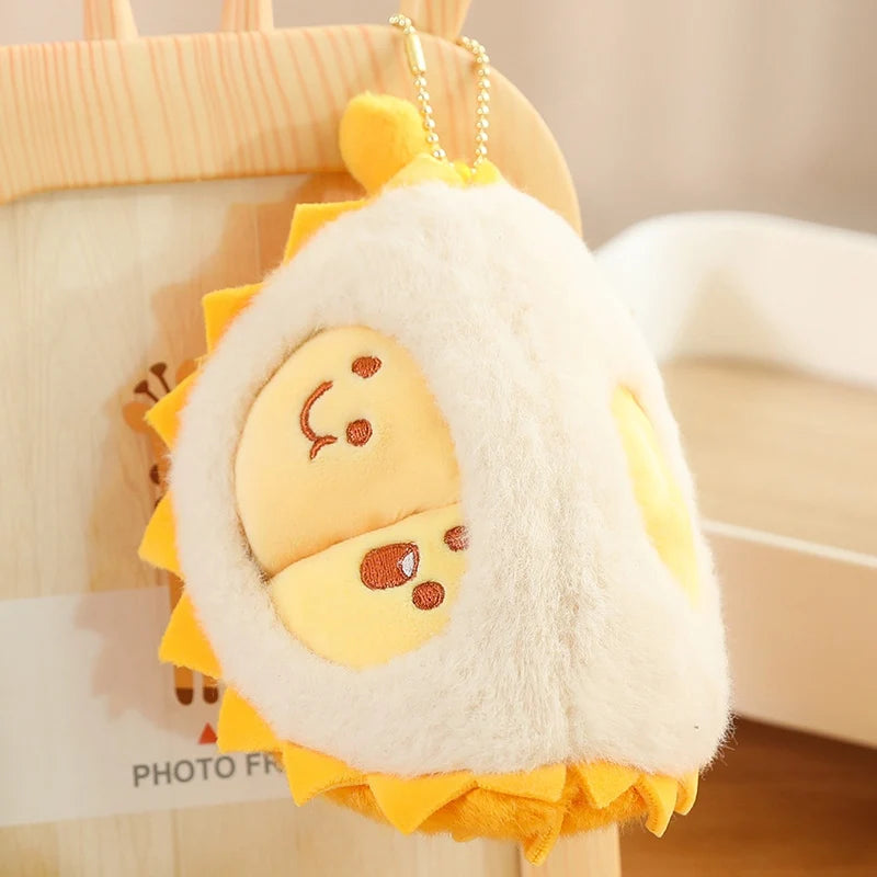 Plush durian keychain on a blurred background
