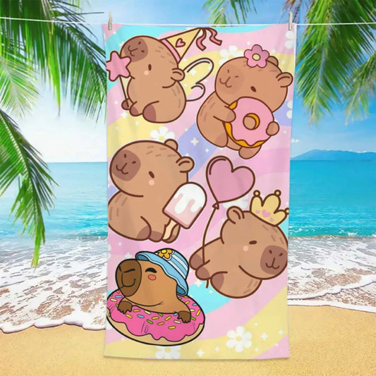 Colorful towel with cartoon cqapybaras on a beach background