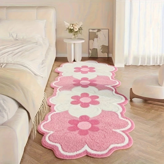 Pink floral rug on a wooden floor in a living room setting.