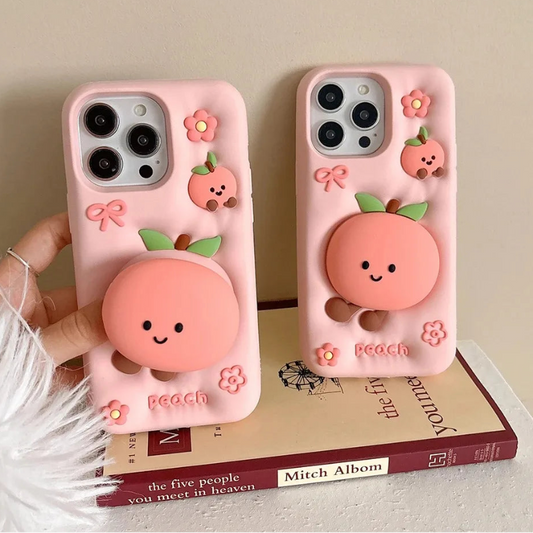 Rear view of Kawaii Peach iPhone Cases displayed on a book held by a woman.