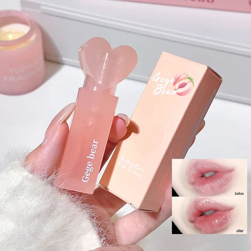 Lip balm with heart-shaped applicator and packaging held by a hand, with close-up of lips wearing the lip balm.