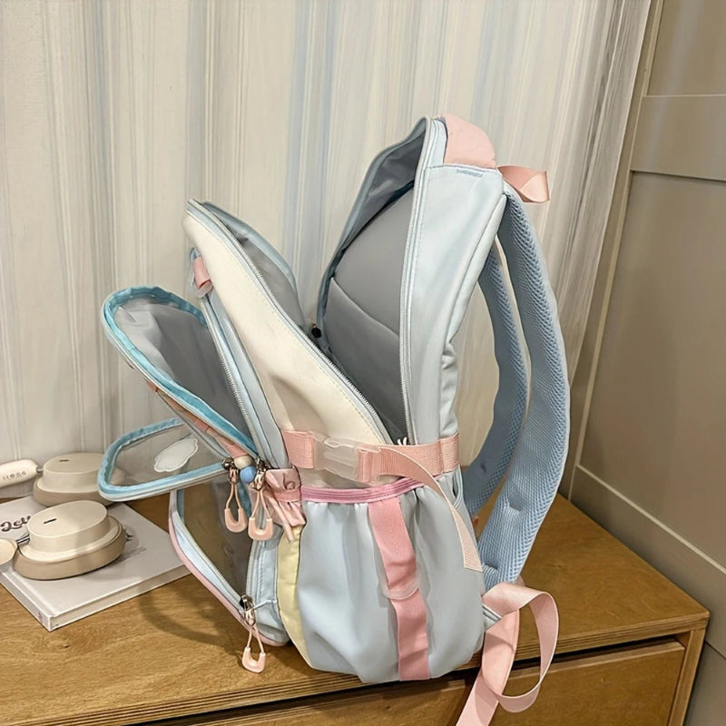 Light blue and pink backpack on a wooden surface with a neutral background