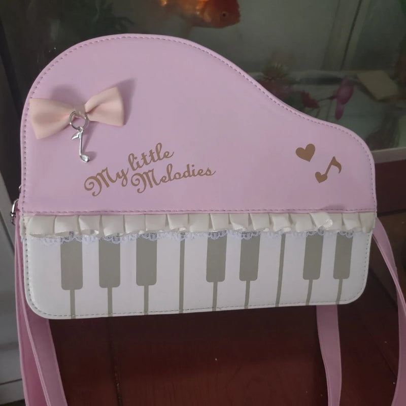 Kawaii pink bag designed like a piano with 'My little Melodies' text and musical notes.