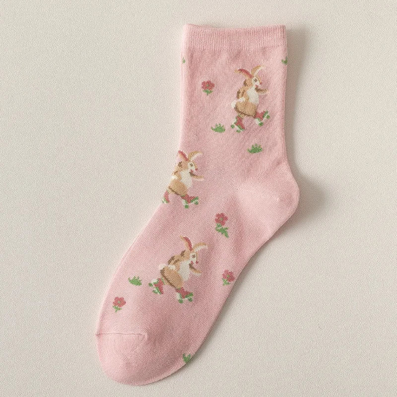 Pink sock with bunny pattern on a beige background