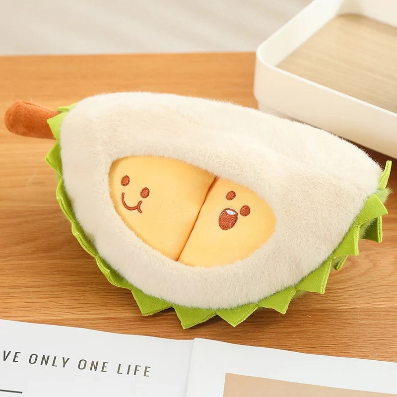 Plush durian toy with smiling face on a wooden surface