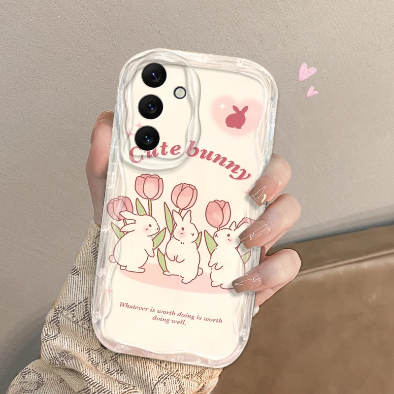 Phone case with cute bunny design held by a hand against a neutral background