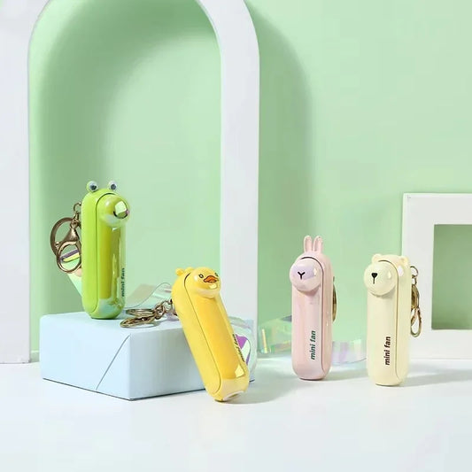 Four small animal-themed fans on a light green background