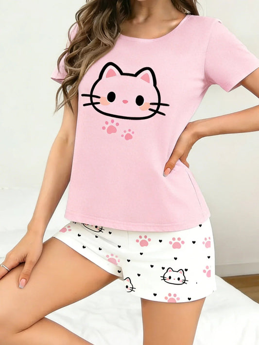 Person wearing a pink t-shirt with a kawaii cat face design and white shorts with cat face and paw prints on a plain background.