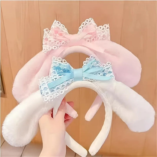 Woman holding the Kawaii Bunny Ears Headbands, displaying the white and blue version and the pink version.