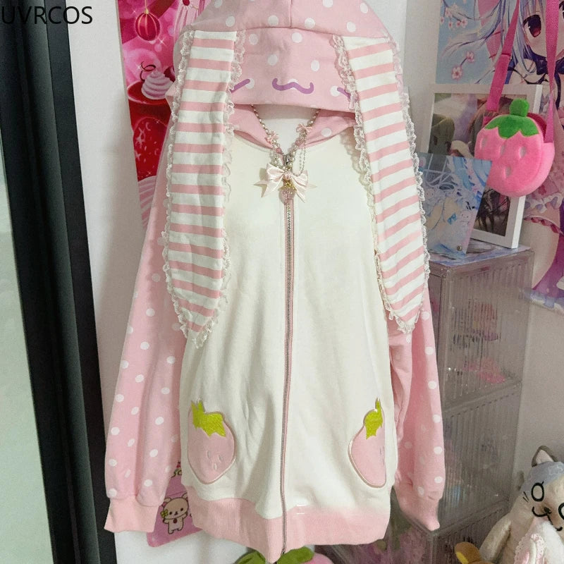 Pink and white hoodie with ruffles and polka dots in a room setting