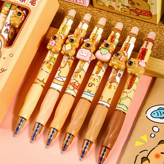 Set of cute capybara pens, displayed on a wooden surface.