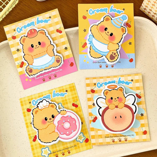 This image is displaying the 4pcs Creamy Bear Sticky Notes 4 different designs that come in the pack, this is shown on a wooden desk.
